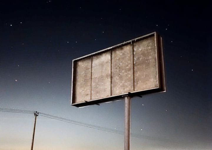 A blank sign with starry skies behind