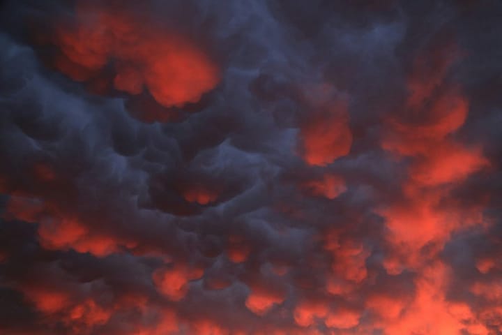 Dark smoky clouds lit up red