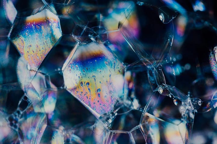 Close-up of a cluster of soap bubbles on black background.